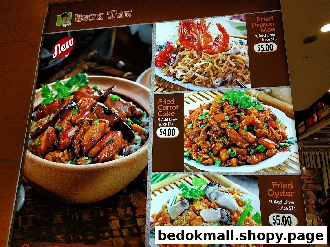 A menu board displaying various food dishes with prices from Encik Tan.