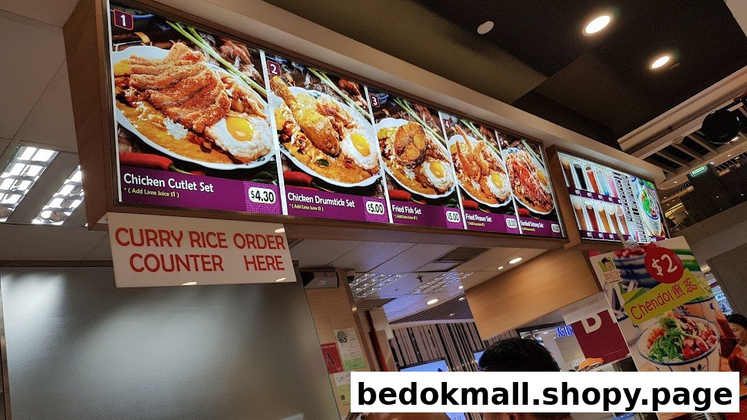 Digital menu board displaying various food items and prices at a food stall.