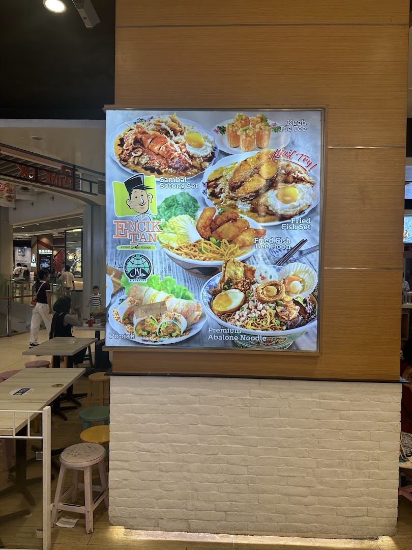 Large illuminated menu board displaying various food dishes from Encik Tan.