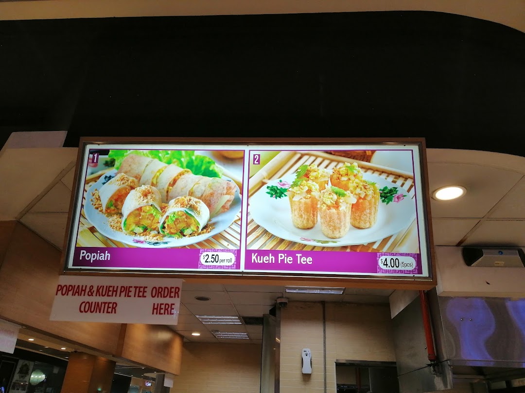 Menu board displaying Popiah and Kueh Pie Tee with prices.