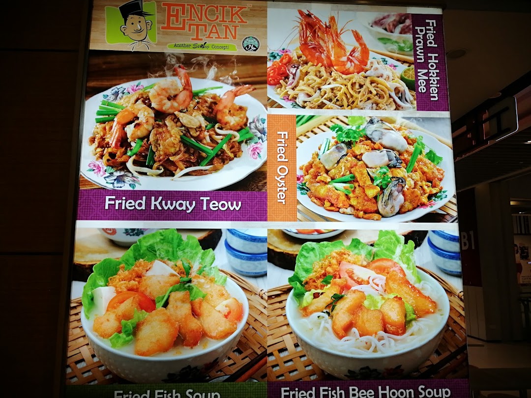 A large display board showing various food dishes and their names.