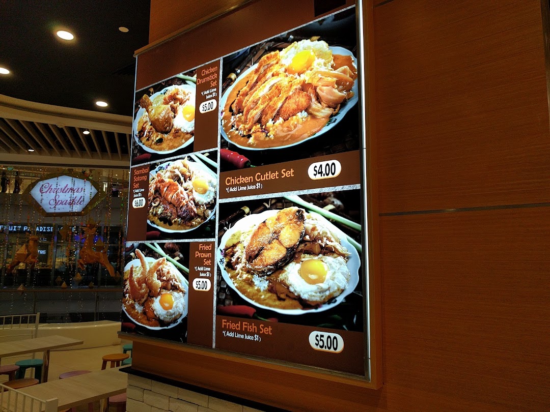 Large illuminated menu board displaying various food dishes with prices.