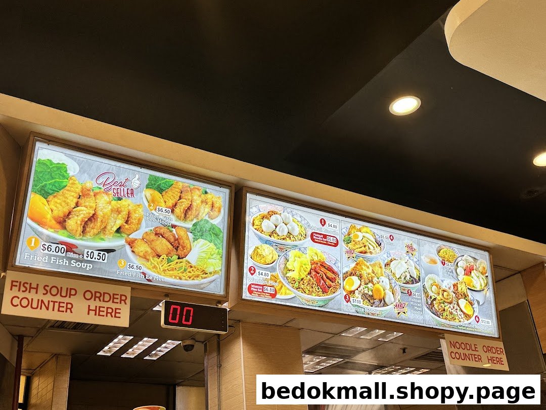 Illuminated menu boards display various food items and prices above order counters.