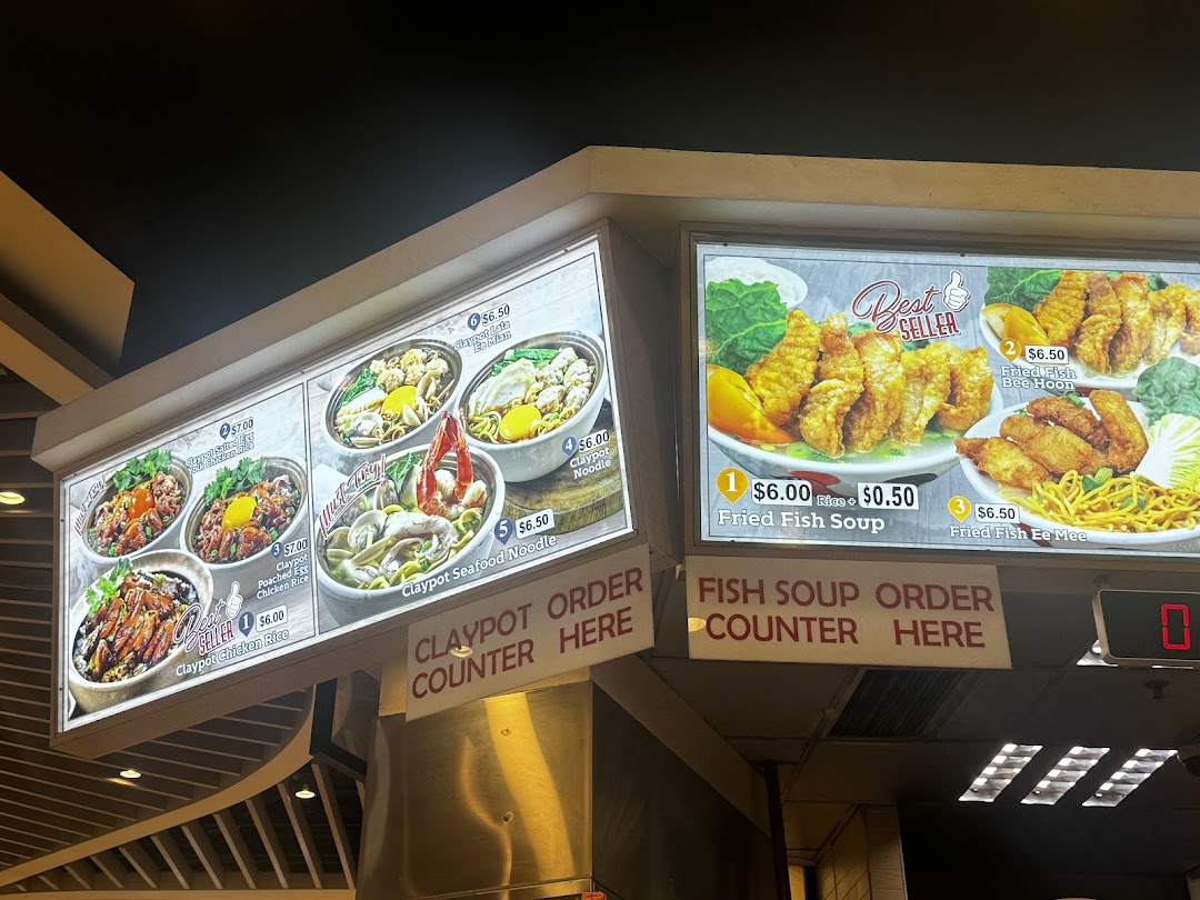 Illuminated menu boards displaying various food items and prices.