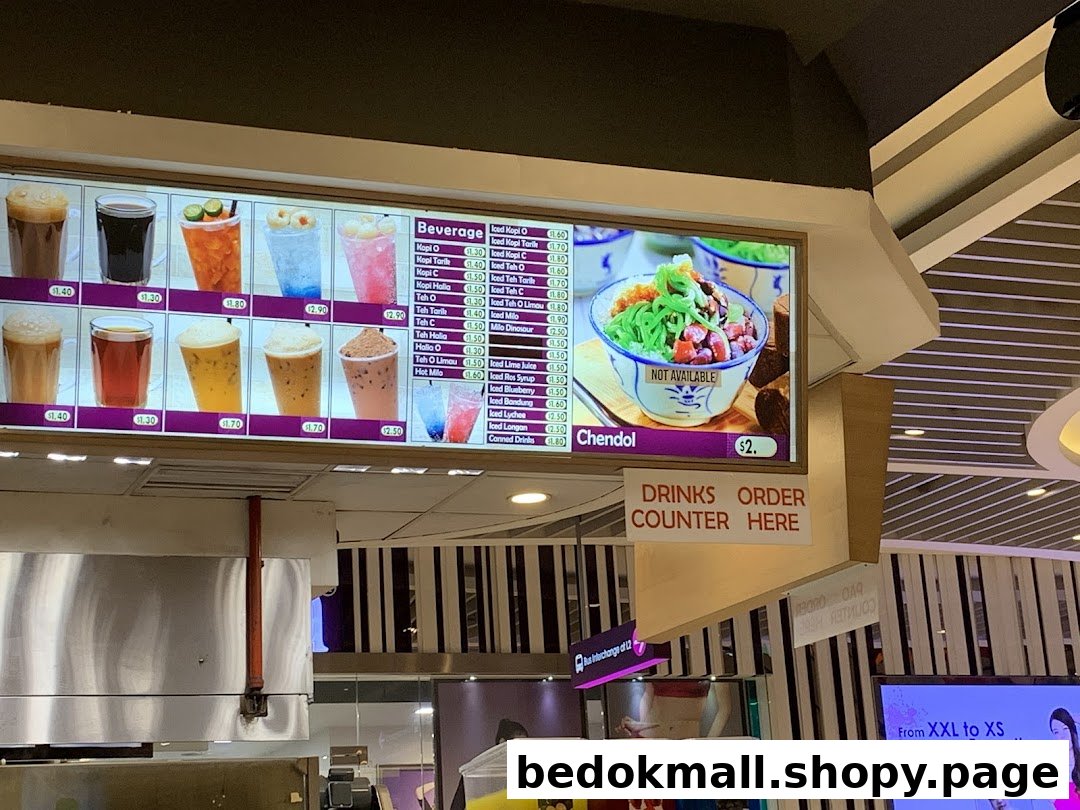 A digital menu board displaying various beverages and prices inside a shop.