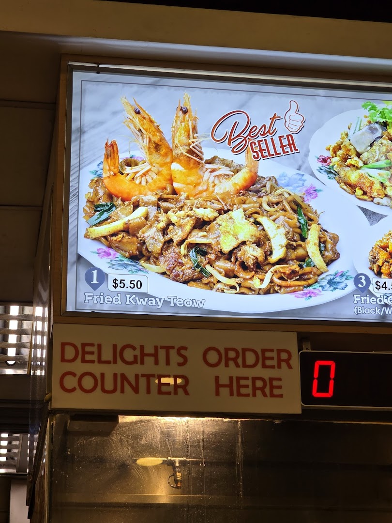 A food display board showing Fried Kway Teow with prawns and prices.