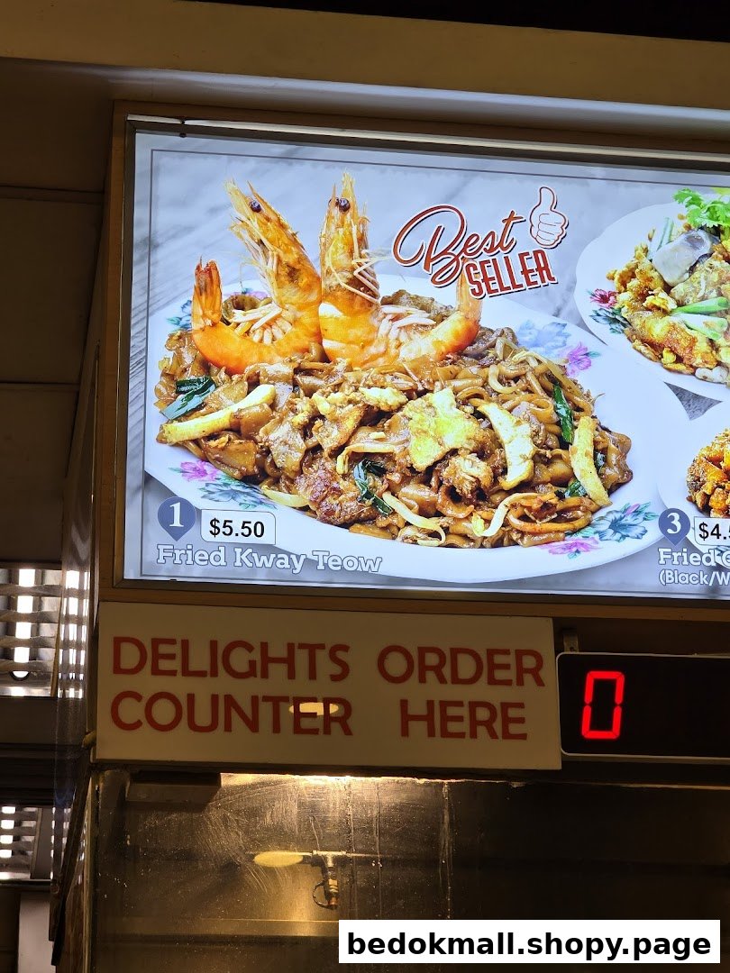 A food display board showing Fried Kway Teow with prawns and prices.