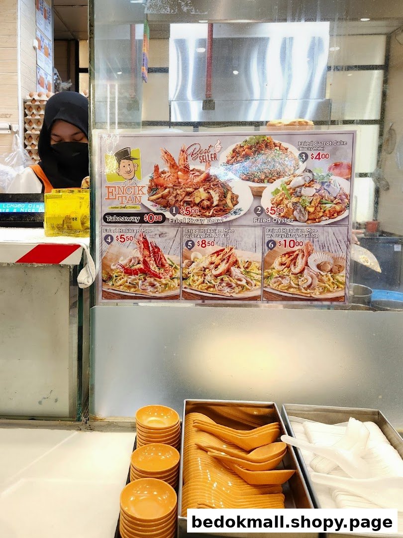 Food stall counter with large menu display and utensils.