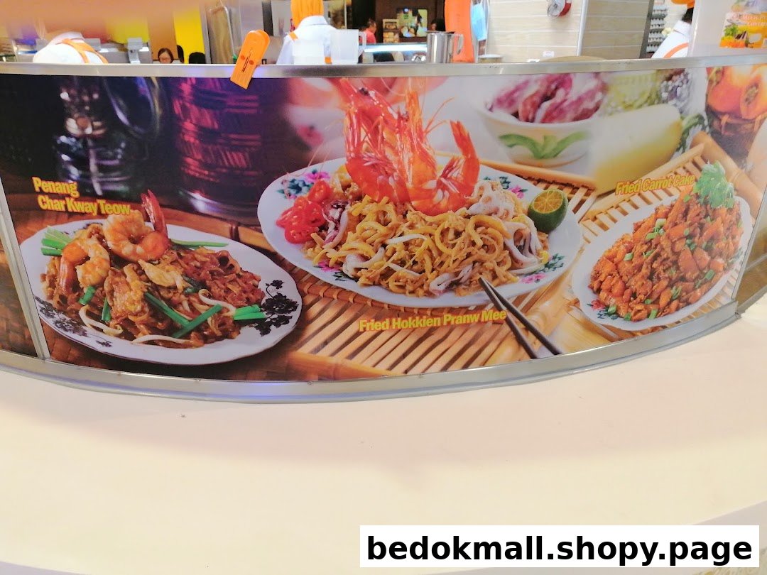 A display board showcasing Encik Tan's popular local dishes: Char Kway Teow, Hokkien Prawn Mee, and Fried Carrot Cake.