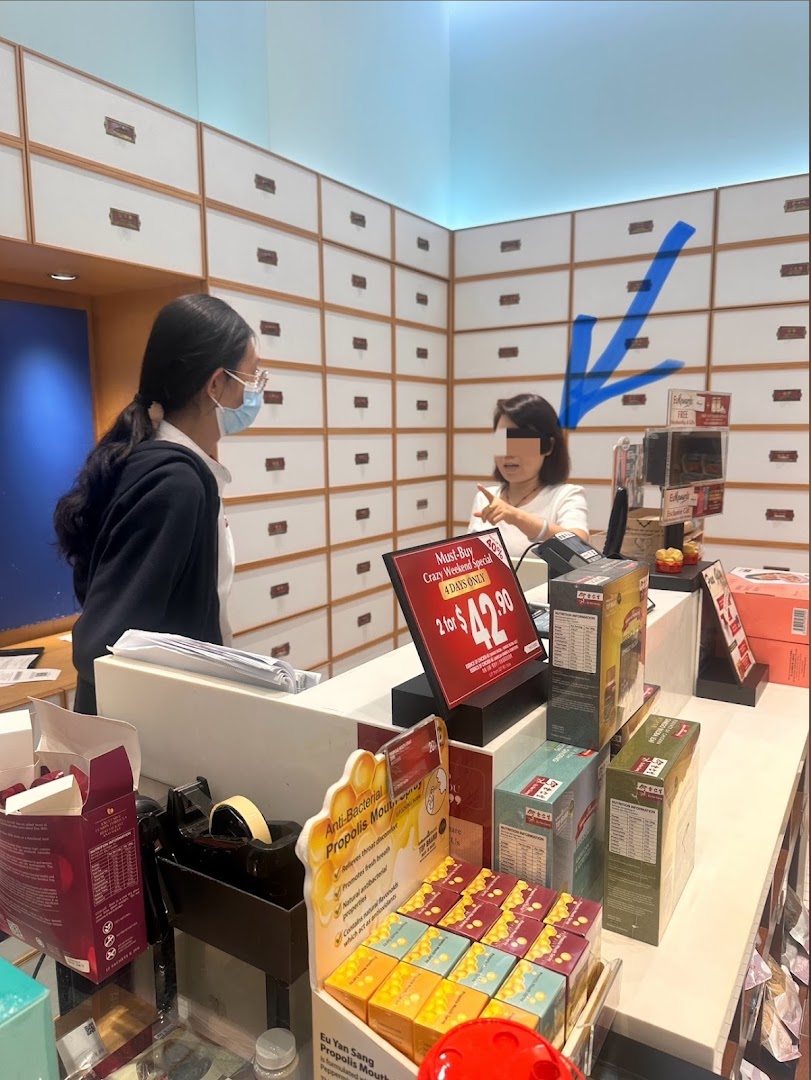 Interior of a shop with staff, customer, products, and traditional drawers.