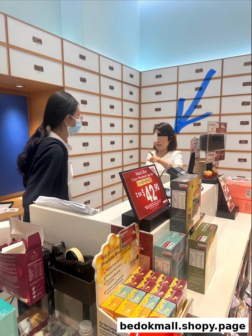 Interior of a shop with staff, customer, products, and traditional drawers.