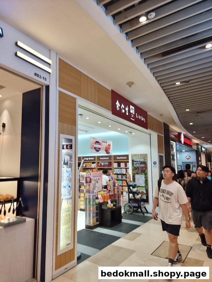 Shop entrance with interior visible and people walking by in a mall.
