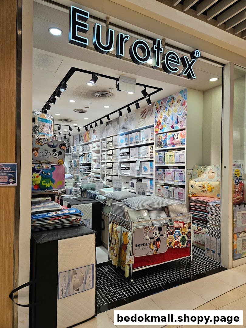 Shop entrance with Eurotex sign and bedding products visible inside.