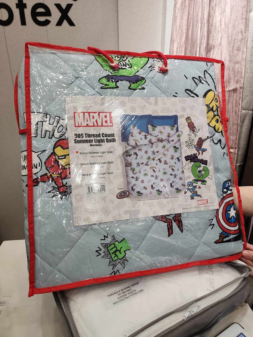 Packaged Marvel-themed quilt displayed in a retail store.