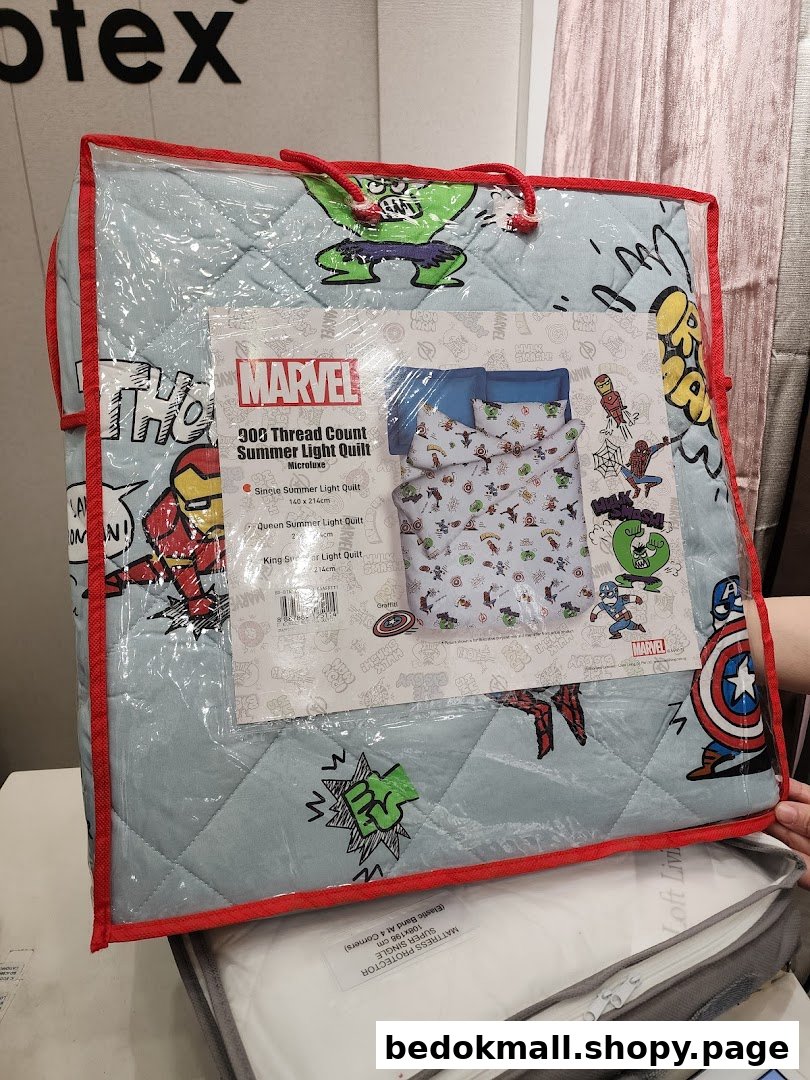 Packaged Marvel-themed quilt displayed in a retail store.