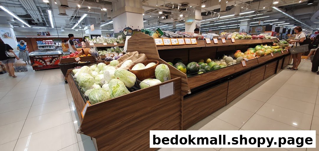 Interior view of a supermarket with fresh produce displays and customers.