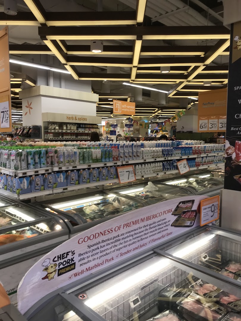 Interior view of a supermarket aisle with products and freezers.