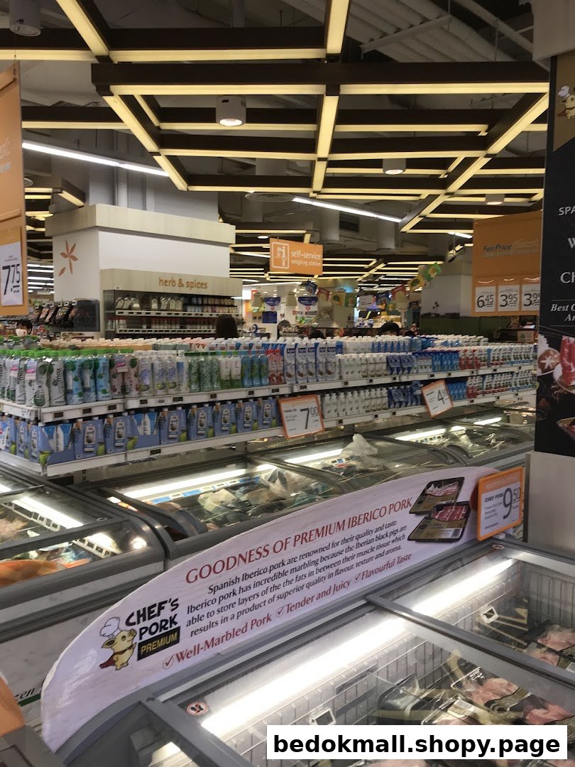 Interior view of a supermarket aisle with products and freezers.