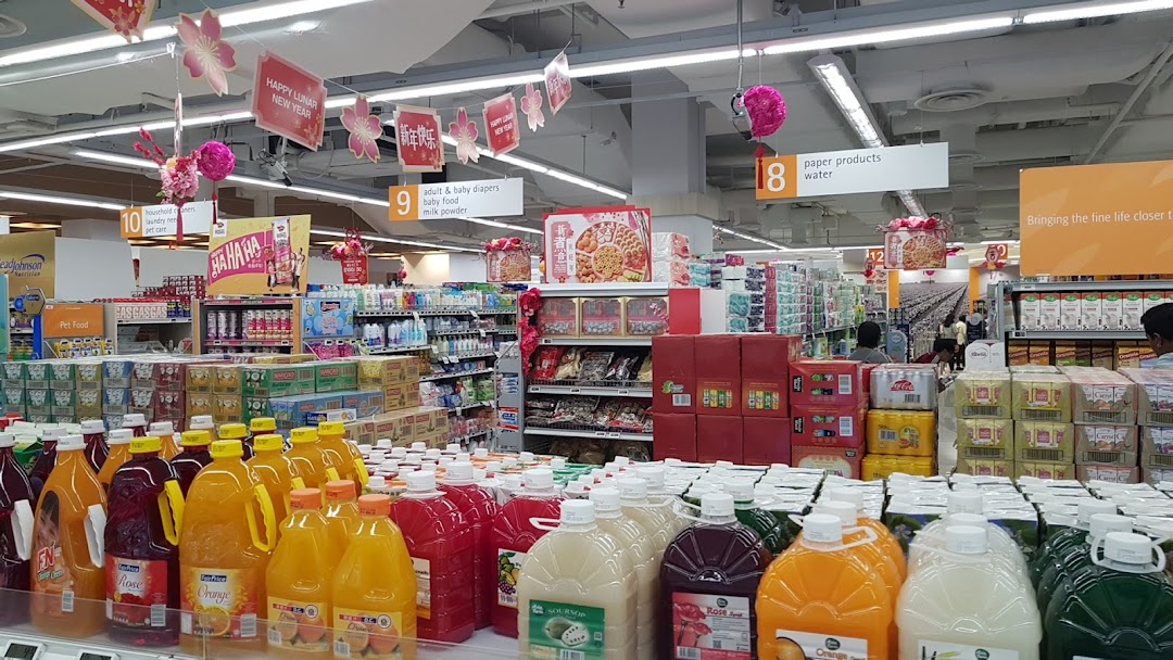 Interior view of a supermarket with aisles of products and Lunar New Year decorations.