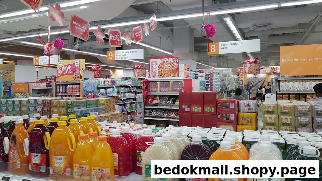 Interior view of a supermarket with aisles of products and Lunar New Year decorations.