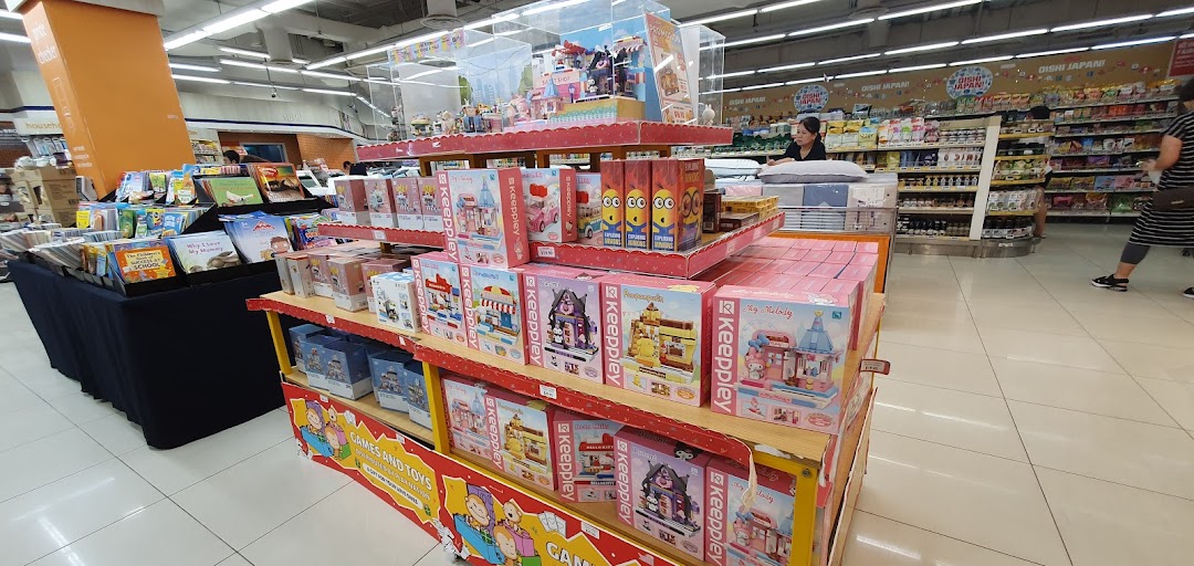Interior view of a supermarket with displays of toys and books.