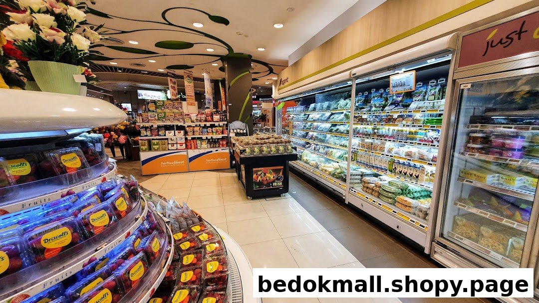 Interior view of a grocery store with produce, refrigerated cases, and shelves.