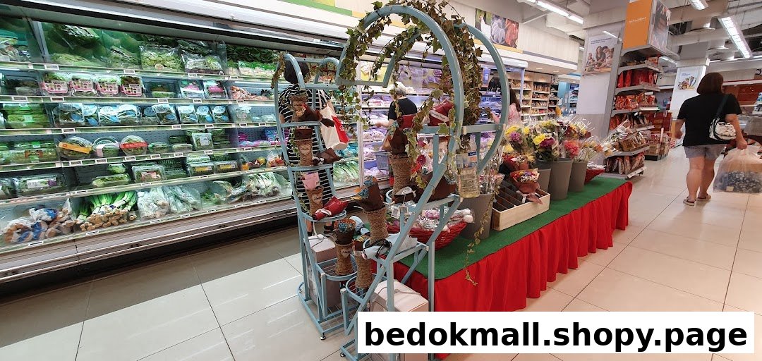 Supermarket interior with produce aisle, flower display, and shoppers.