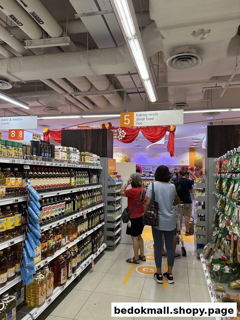 Customers browse a supermarket aisle with shelves stocked with various products.
