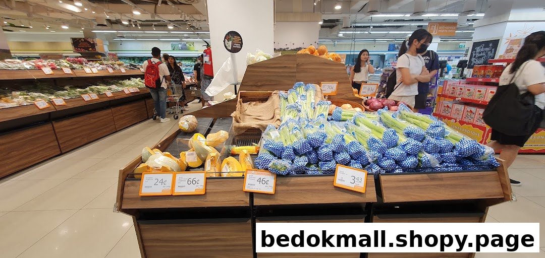Interior view of a supermarket produce section with various vegetables and customers.