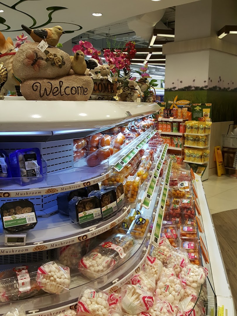 Interior view of a supermarket aisle with packaged mushrooms and produce.