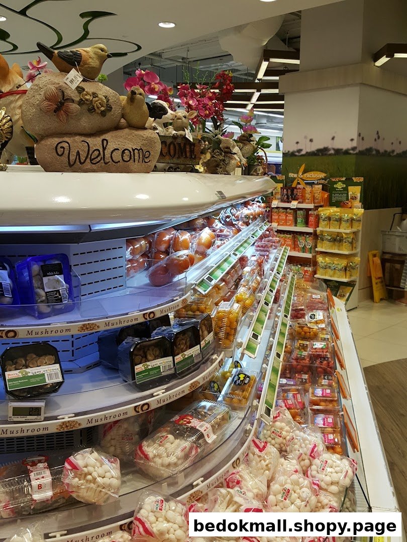 Interior view of a supermarket aisle with packaged mushrooms and produce.