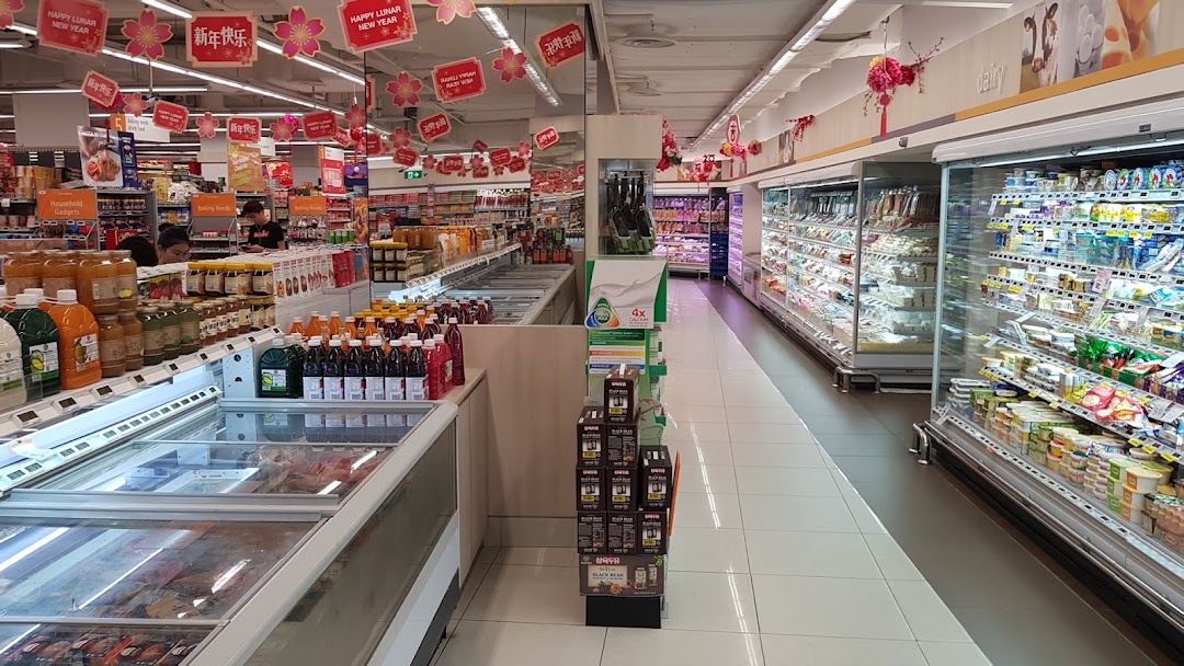 Interior view of a supermarket aisle with refrigerated displays and various products.