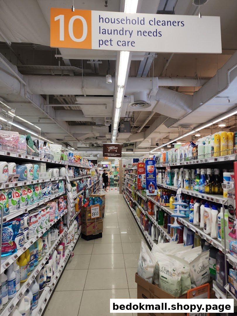 Interior view of a supermarket aisle with household cleaners and pet care products.