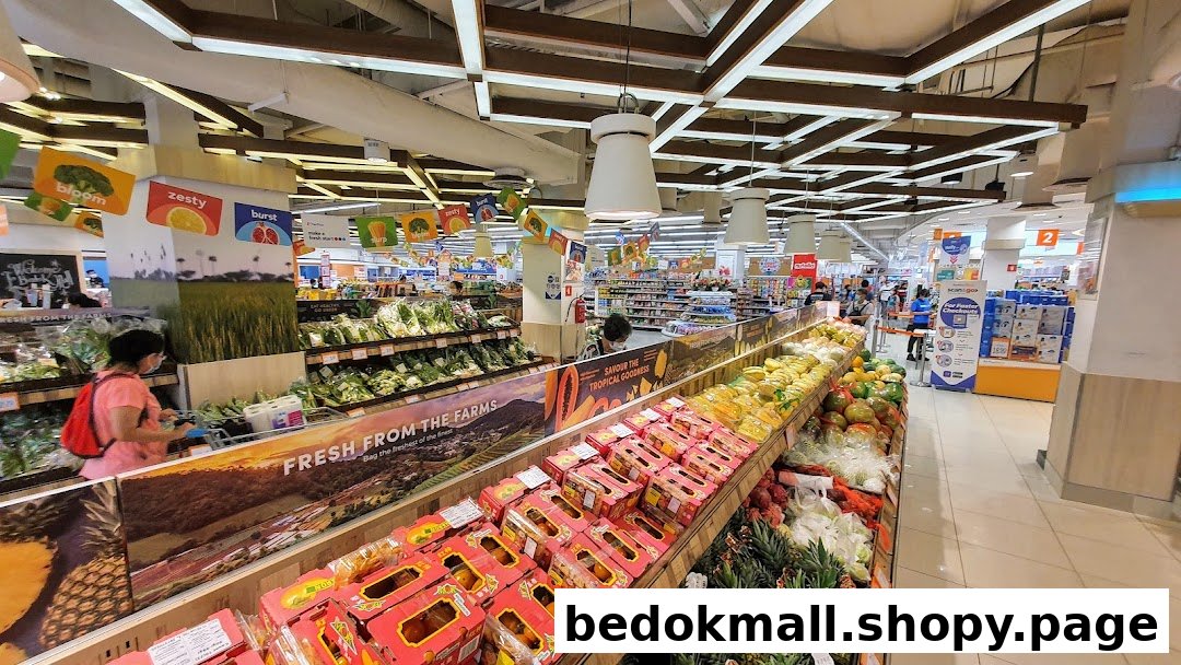 Interior view of a supermarket's fresh produce section with fruits and vegetables.