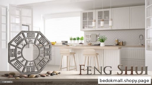 A Bagua mirror and stones on a table with 'FENG SHUI' text in a modern kitchen.