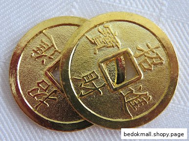 Two golden Chinese-style coins with square holes and characters.