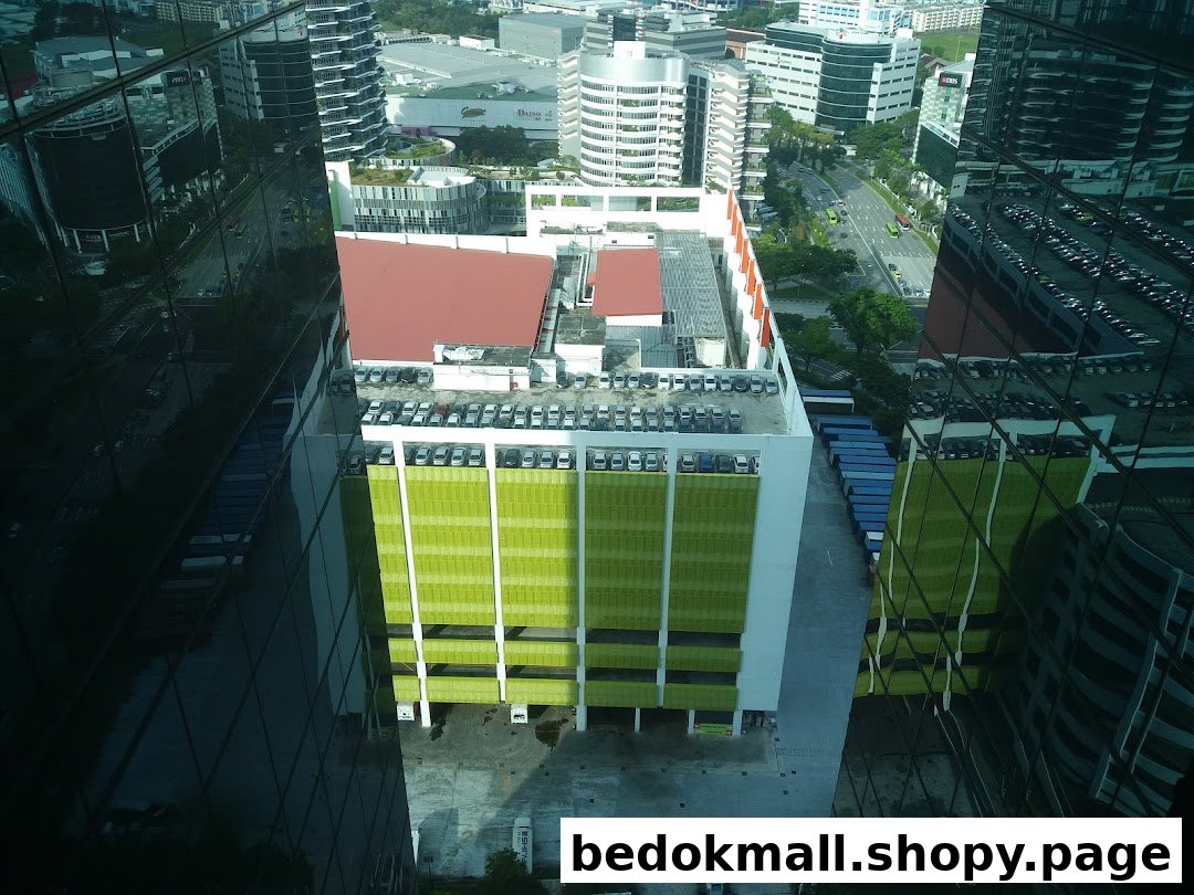 High-angle view of urban landscape with buildings, parking garage, and reflections.