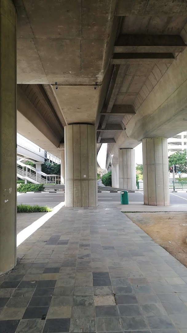 Concrete elevated structure with pillars, tiled walkway, and road visible.