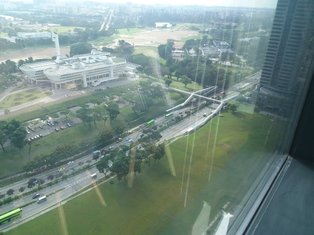 Aerial view of urban landscape with buildings, roads, and green areas.