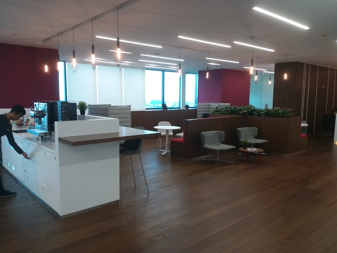 Modern interior lounge area with a counter, seating, and a person.