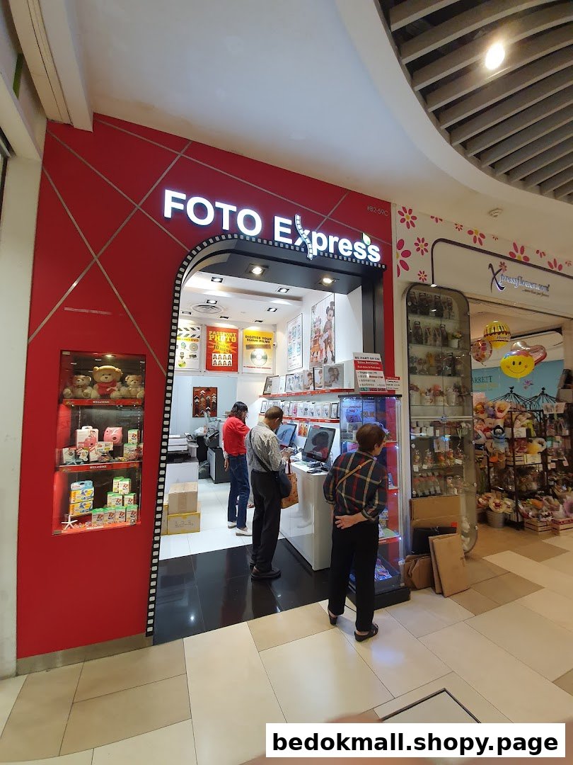 Entrance of Foto Express shop with customers and product displays.