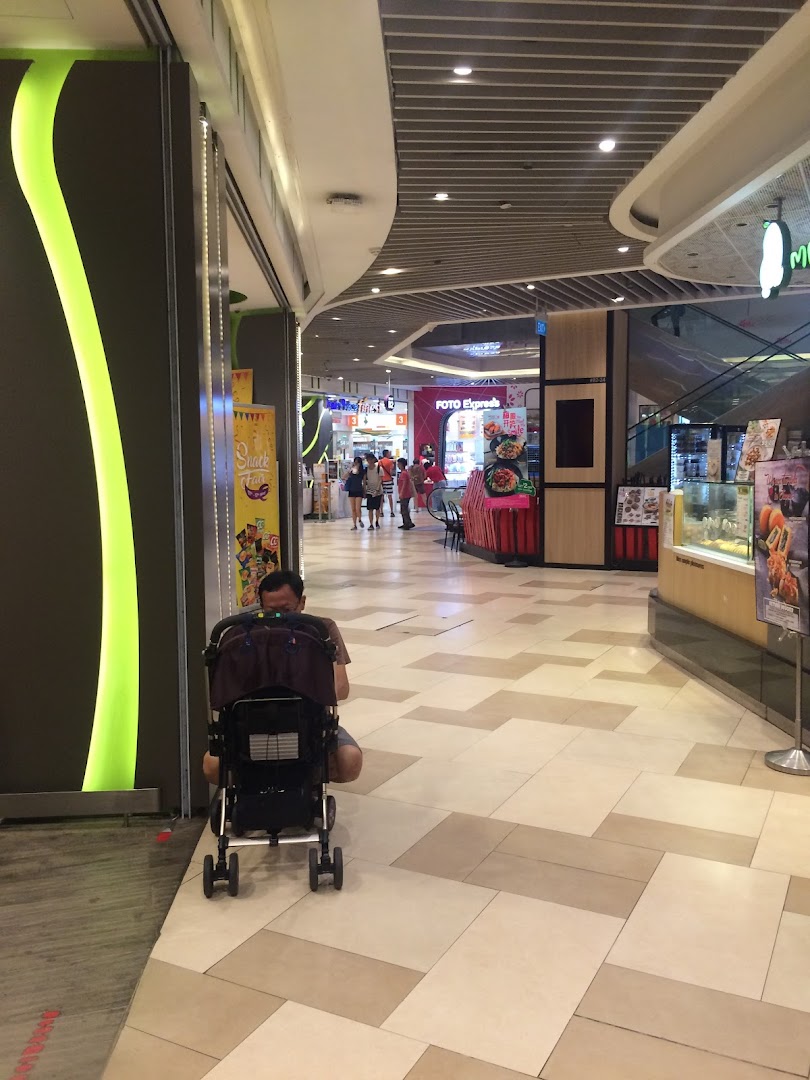 Mall corridor with shops, including Foto Express, and a person with a stroller.