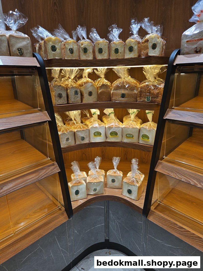Shelves filled with packaged bread loaves inside a bakery.