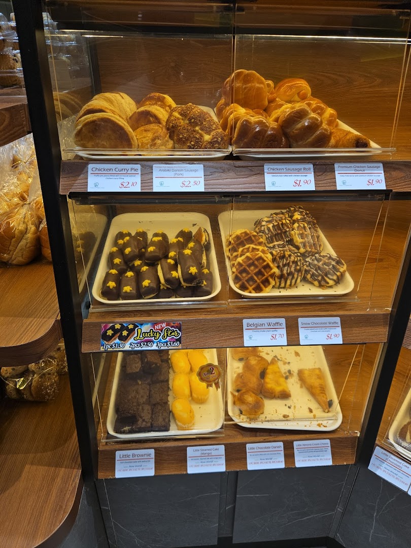 Glass display case filled with various pastries and baked goods.