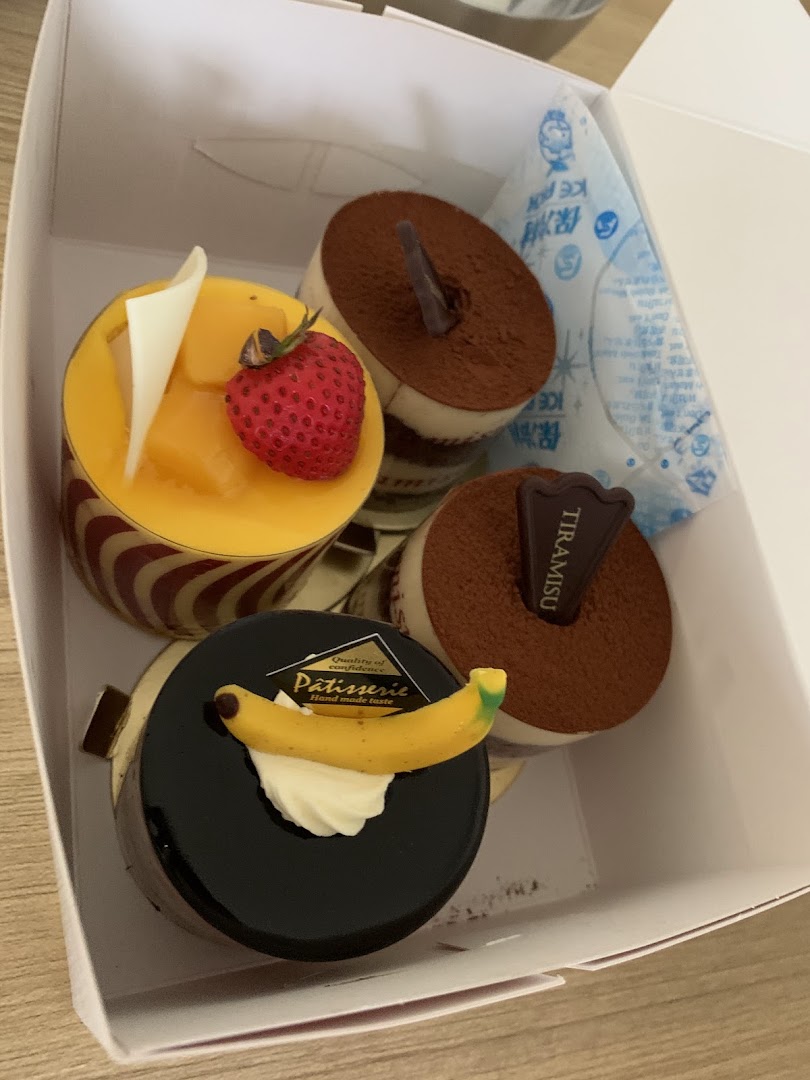Assorted cakes in a white box with an ice pack.