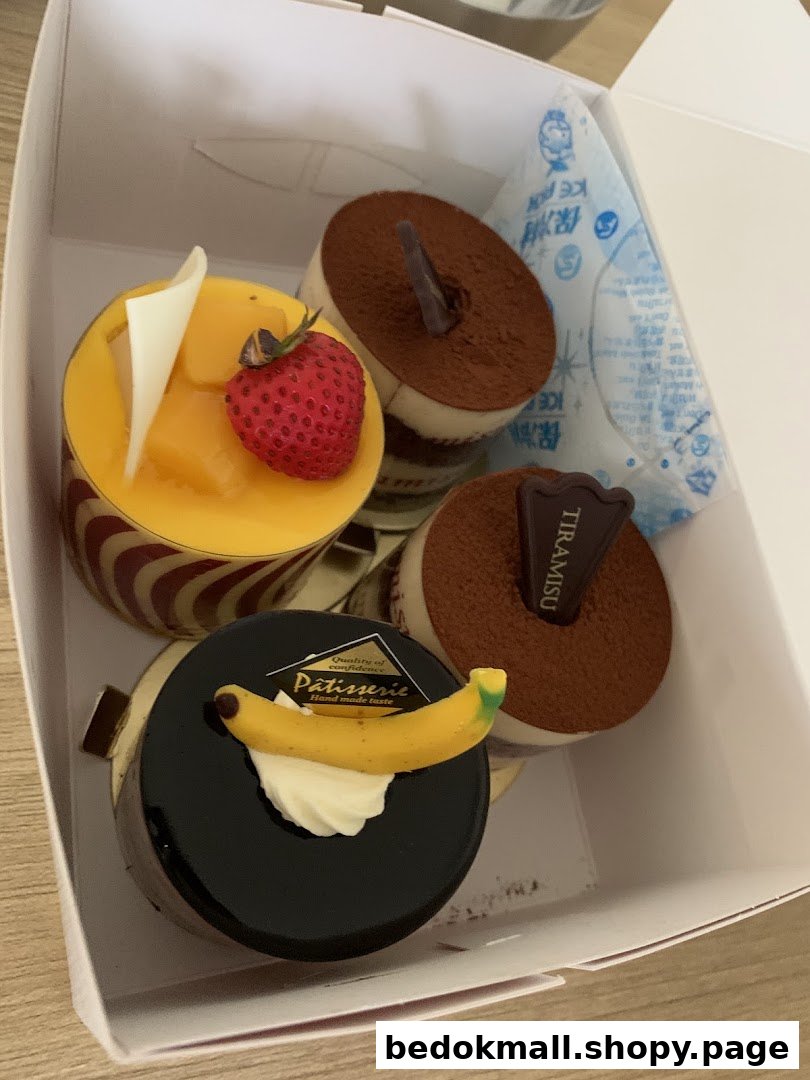 Assorted cakes in a white box with an ice pack.