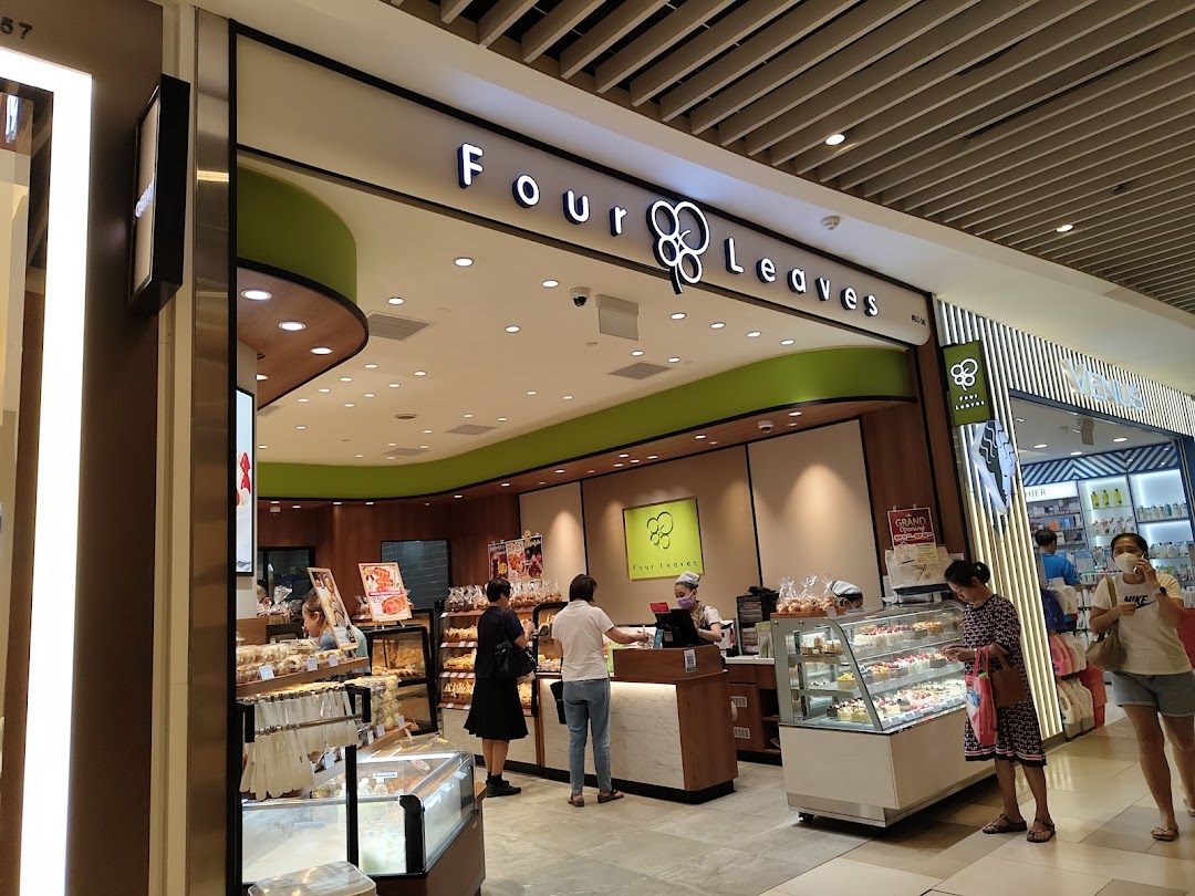 Four Leaves bakery entrance with customers and product displays.