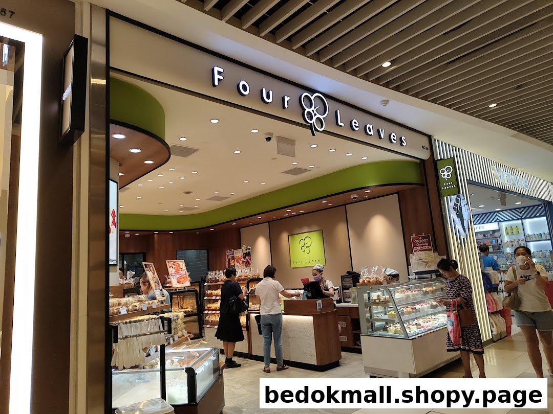 Four Leaves bakery entrance with customers and product displays.