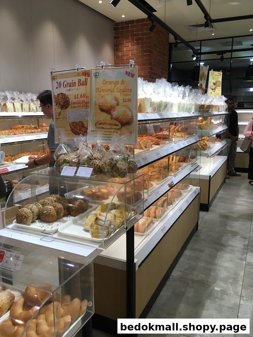 Interior view of a bakery with display cases full of bread and pastries.
