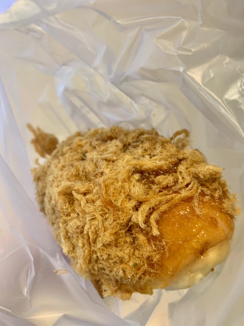 Close-up of a pork floss bun in a clear plastic bag.